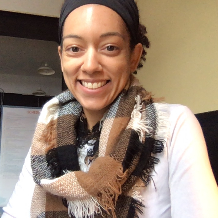 Gena wearing a scarf and smiling